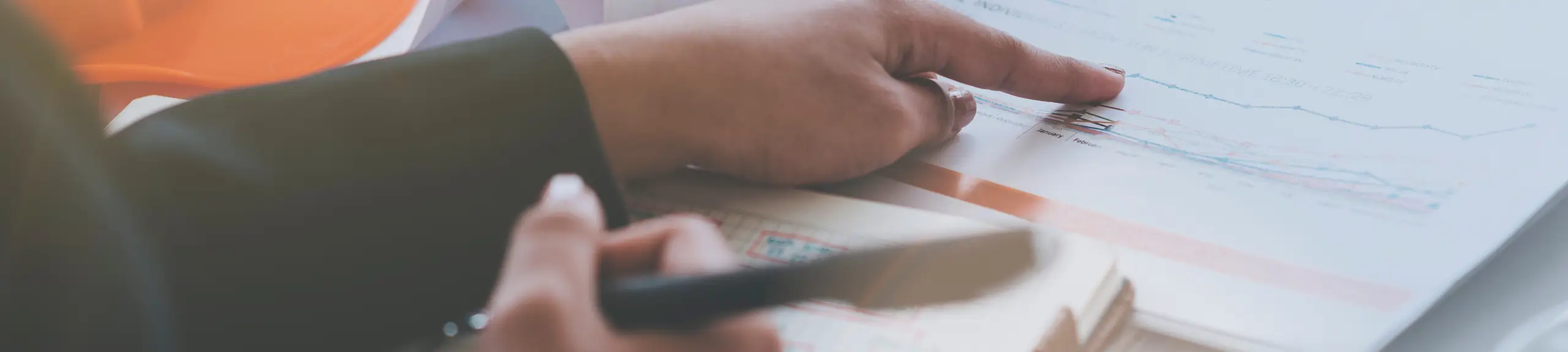 a person's hand checking through a document a person's hand checking through a document